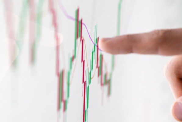 Finger tracing a stock market chart